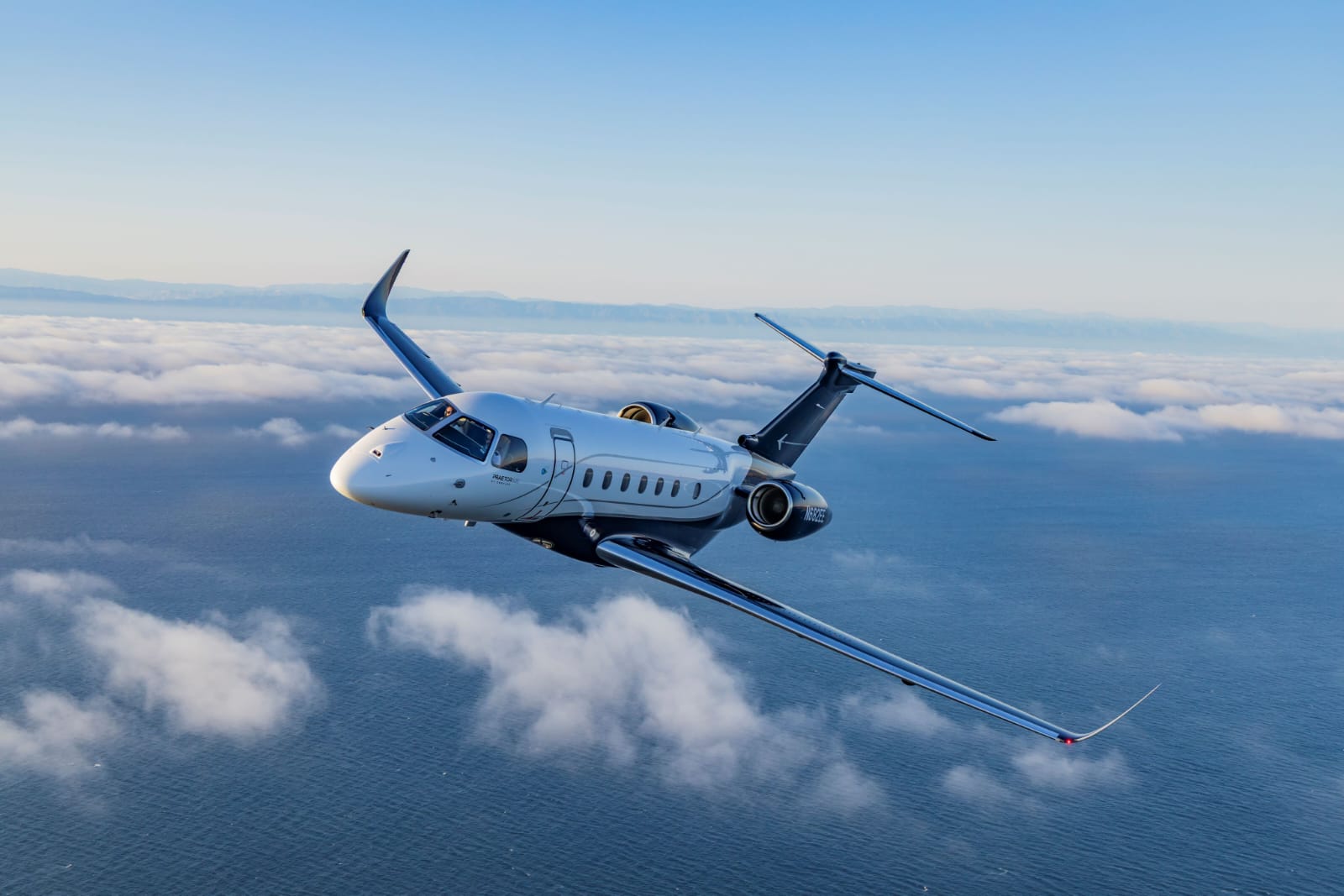 Luxury private jet flying over snowy mountain range