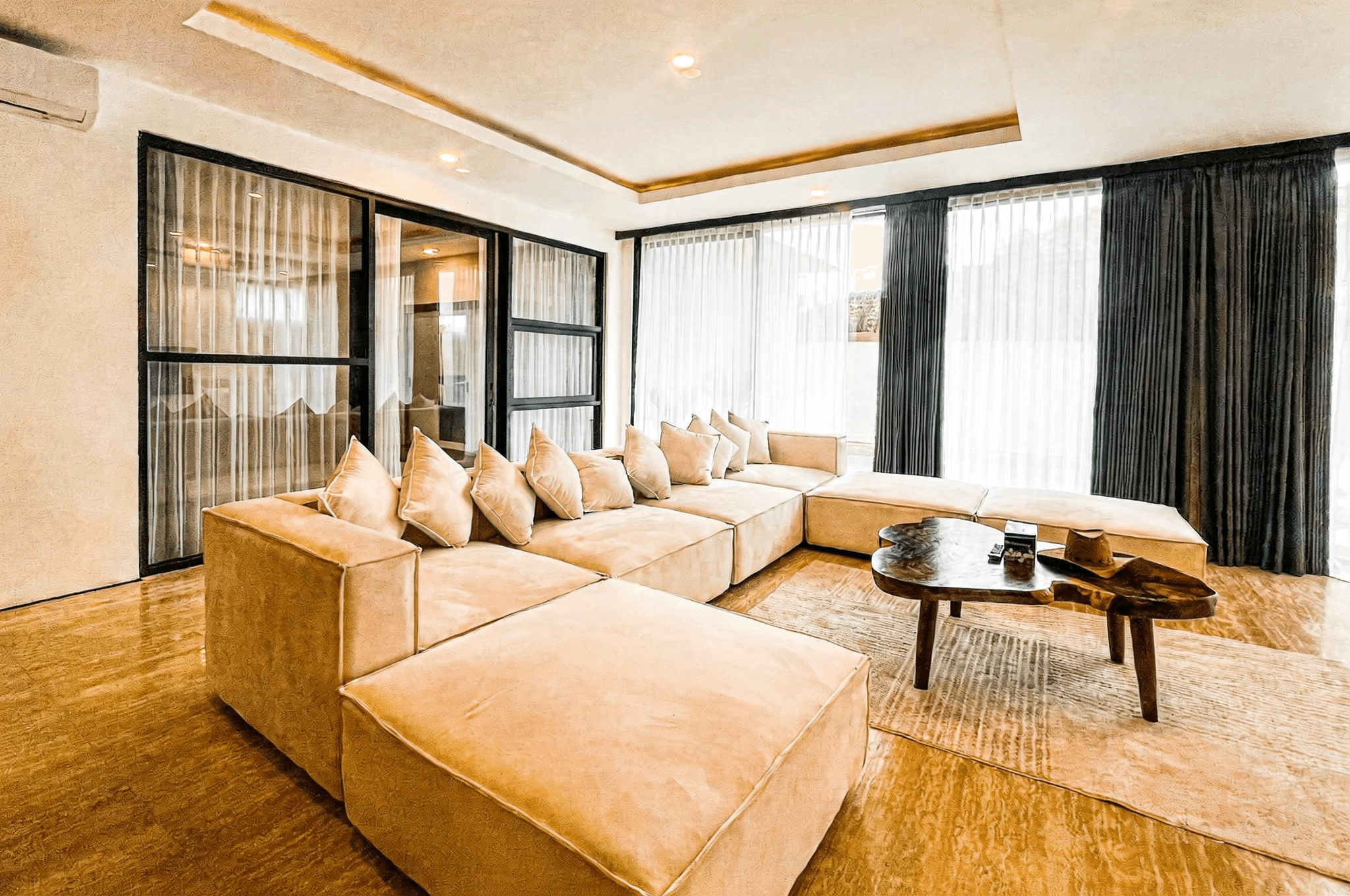Modern open-plan living area at Ungasan I with a large sectional sofa, ideal for Bali property investors.