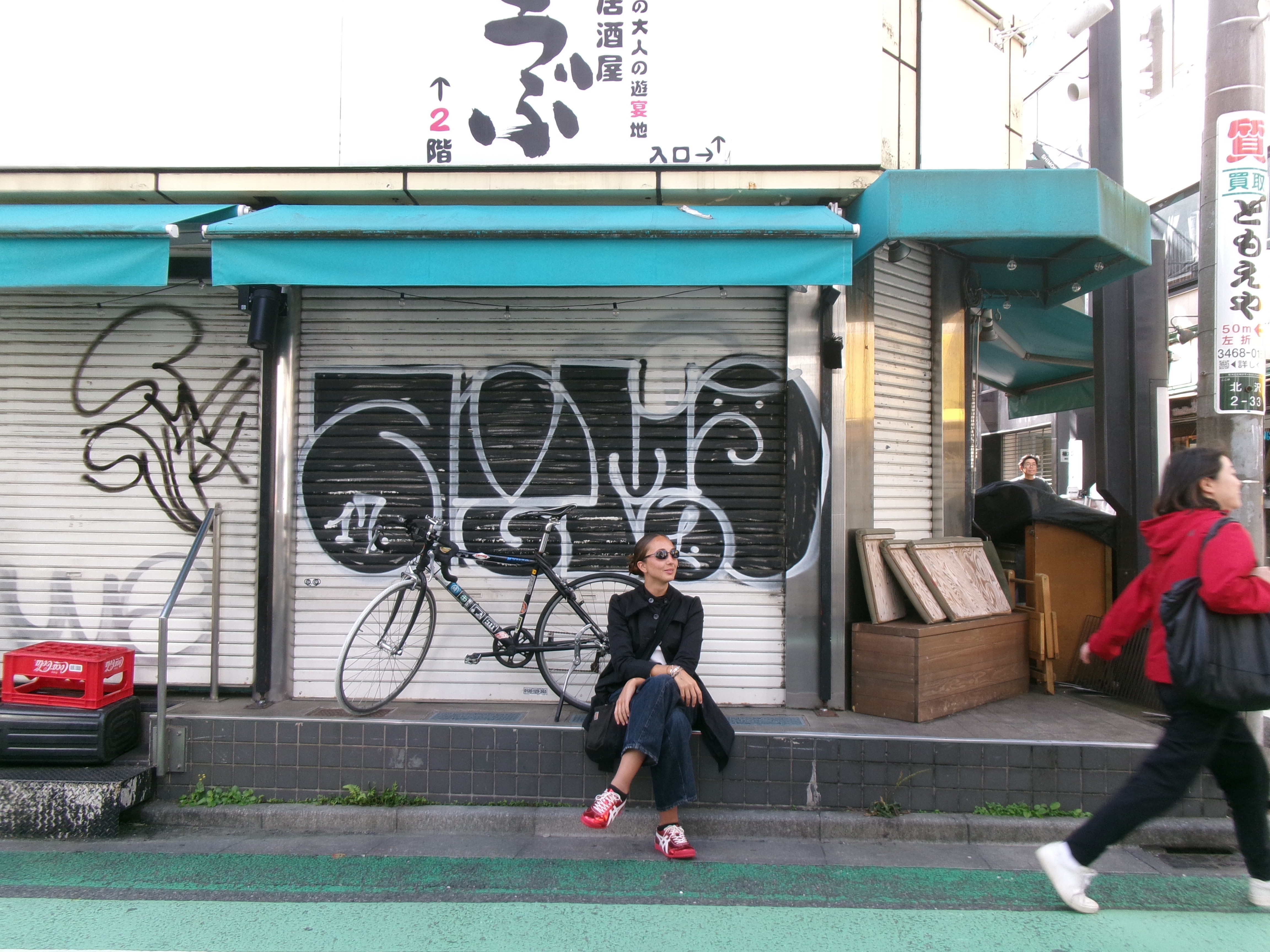 Woman sitting by the road in Tokyo, Japan.