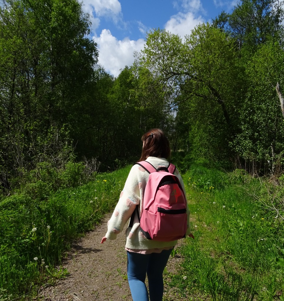 Annika with a pink backpack in a Swedish forest