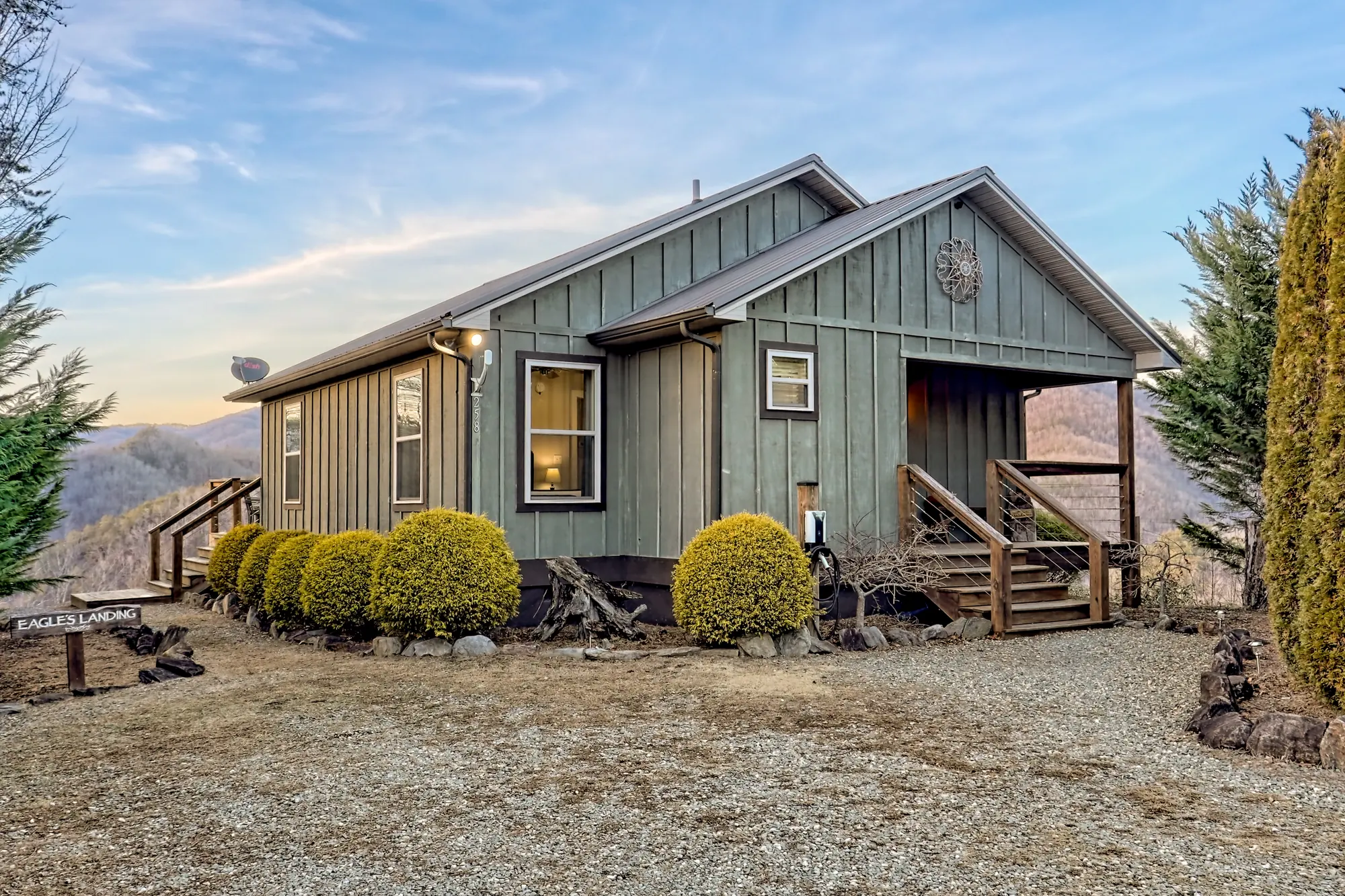 Front of Eagles Landing, a sage board-and-batten cabin with a covered porch