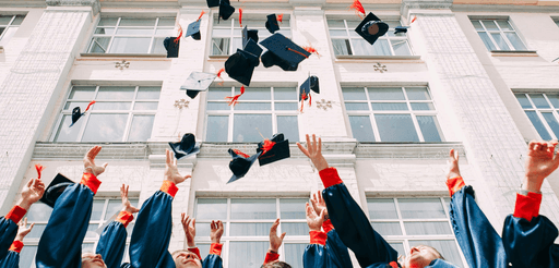 Graduates throwing their caps, scholarhip celebration