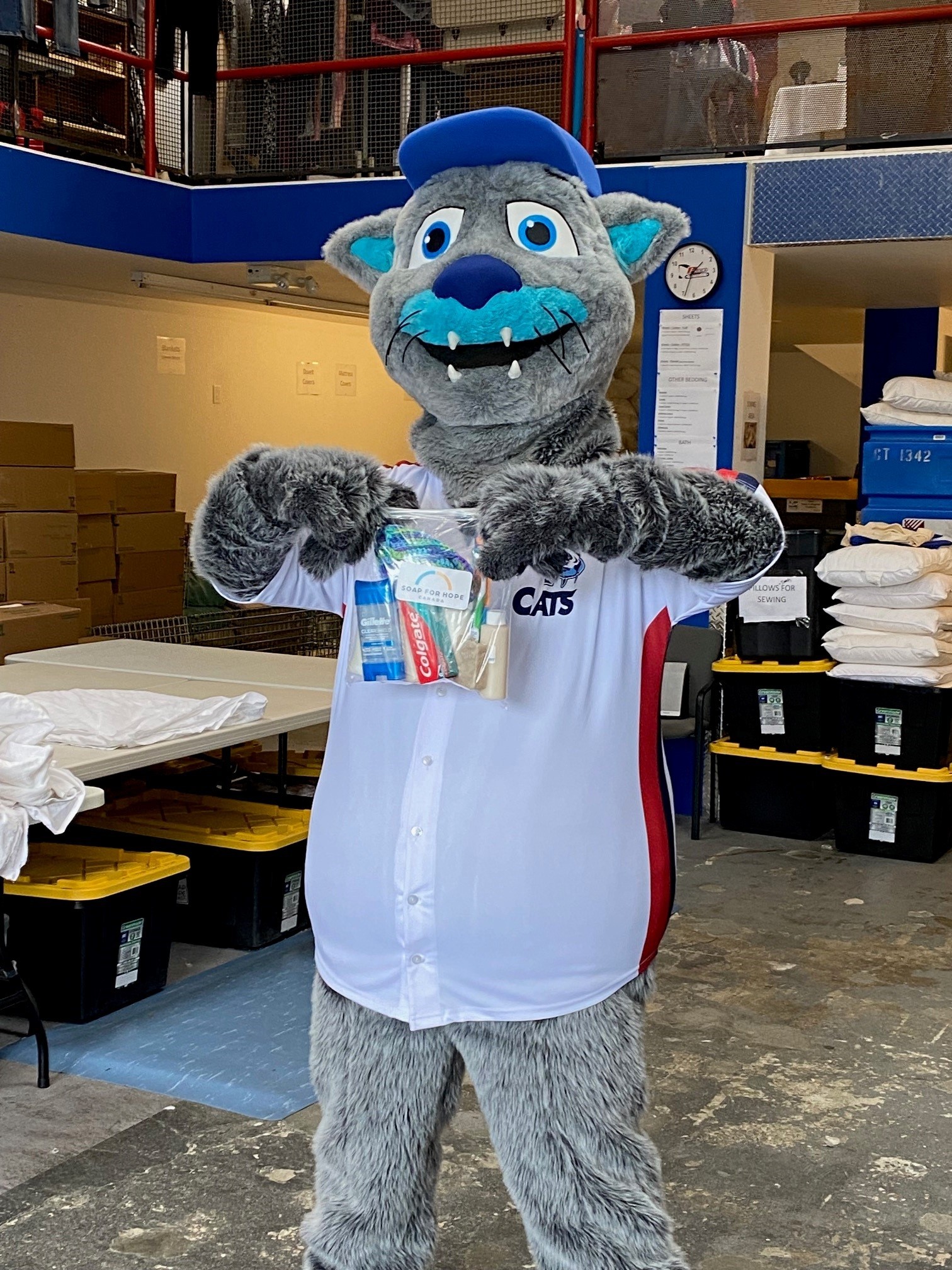 Image for Soap for Hope Canada's CEO with another person with boxes if donated products