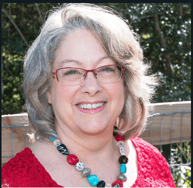 A man standing in front of a window smiling