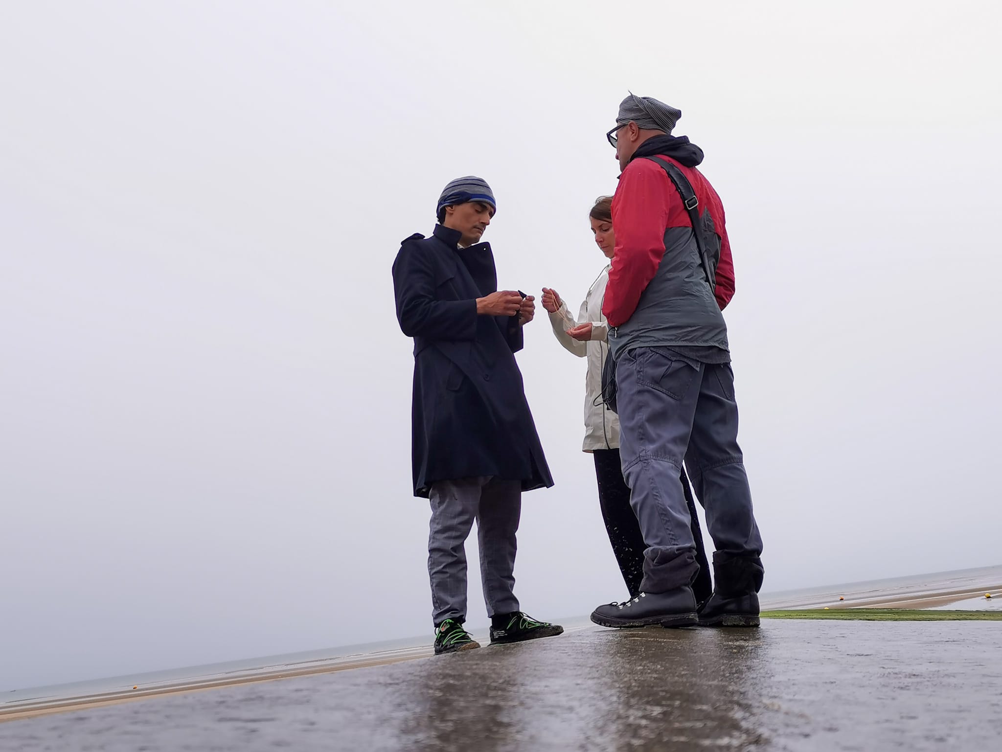 Woman in pink leather jacket crouching outdoors at night