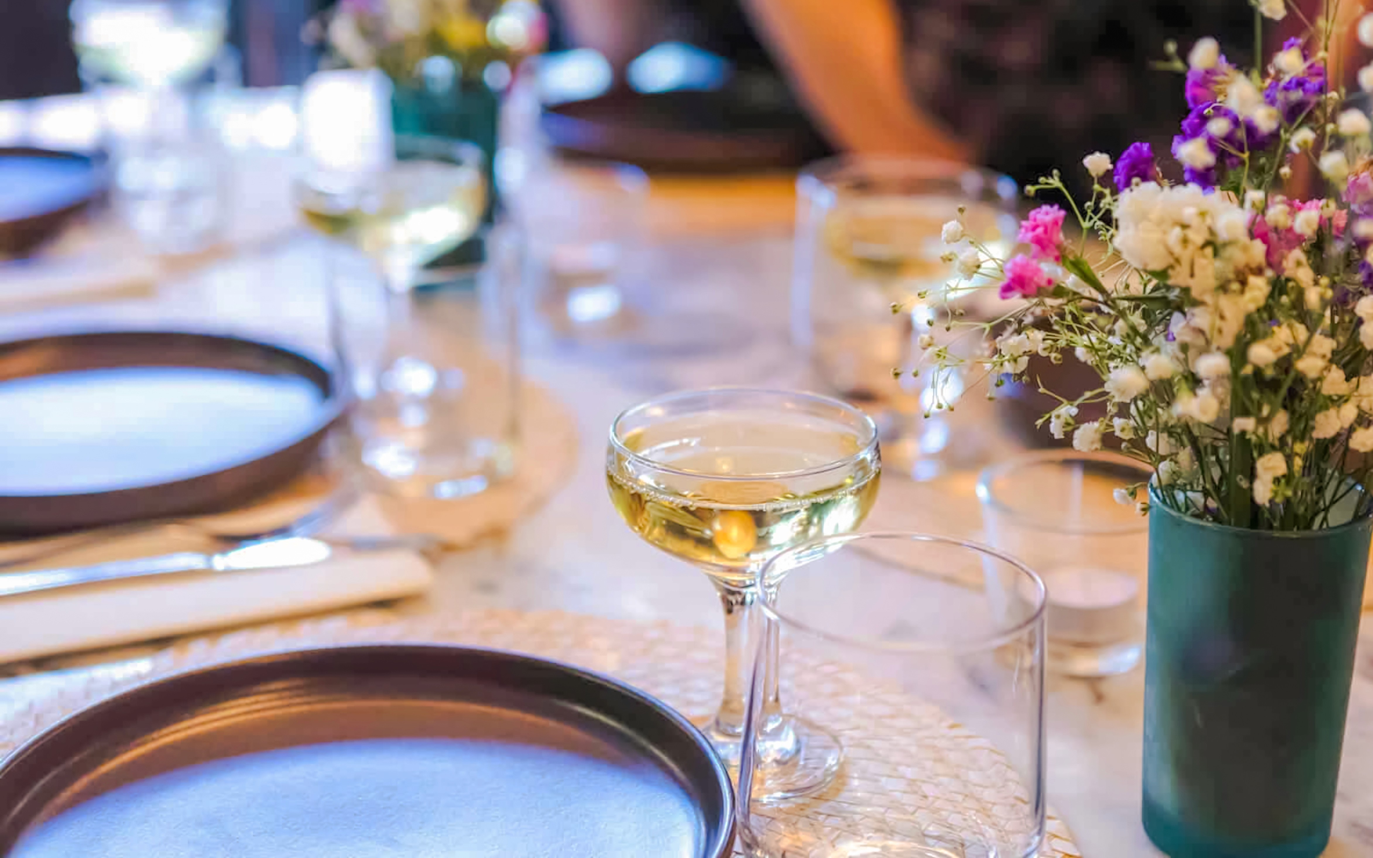 Lisbon food tour table with champagne glass and traditional Portuguese dishes.