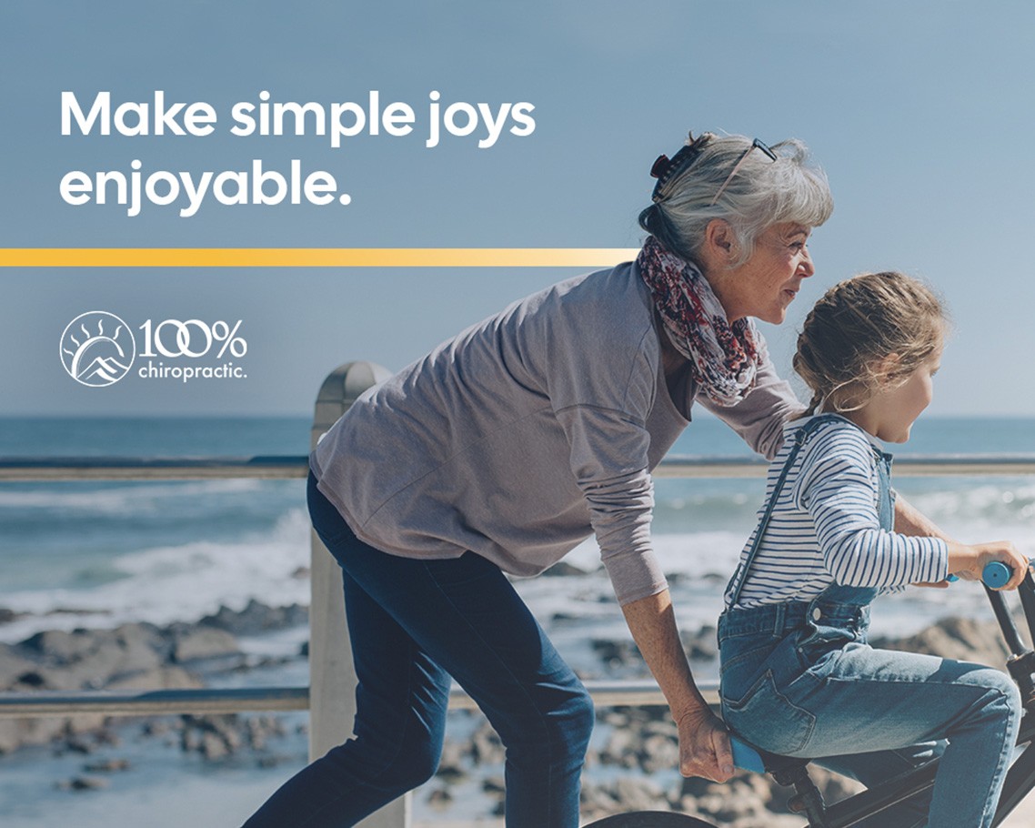 Advertisement showing a grandmother pushing her grandaughter on a bike on an oceanside boardwalk
