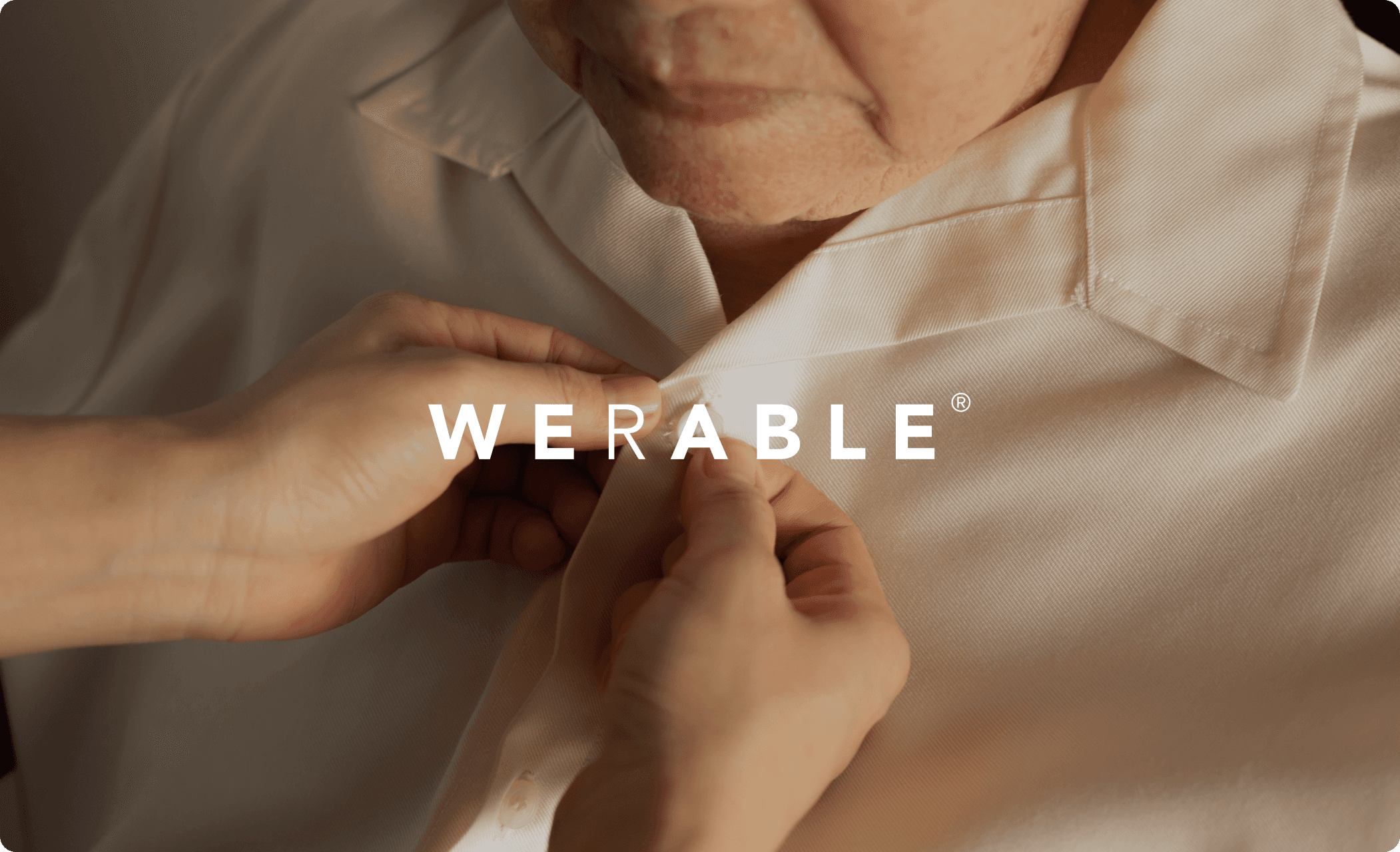 A caregiver dressing an elderly person, featuring the Werable logo