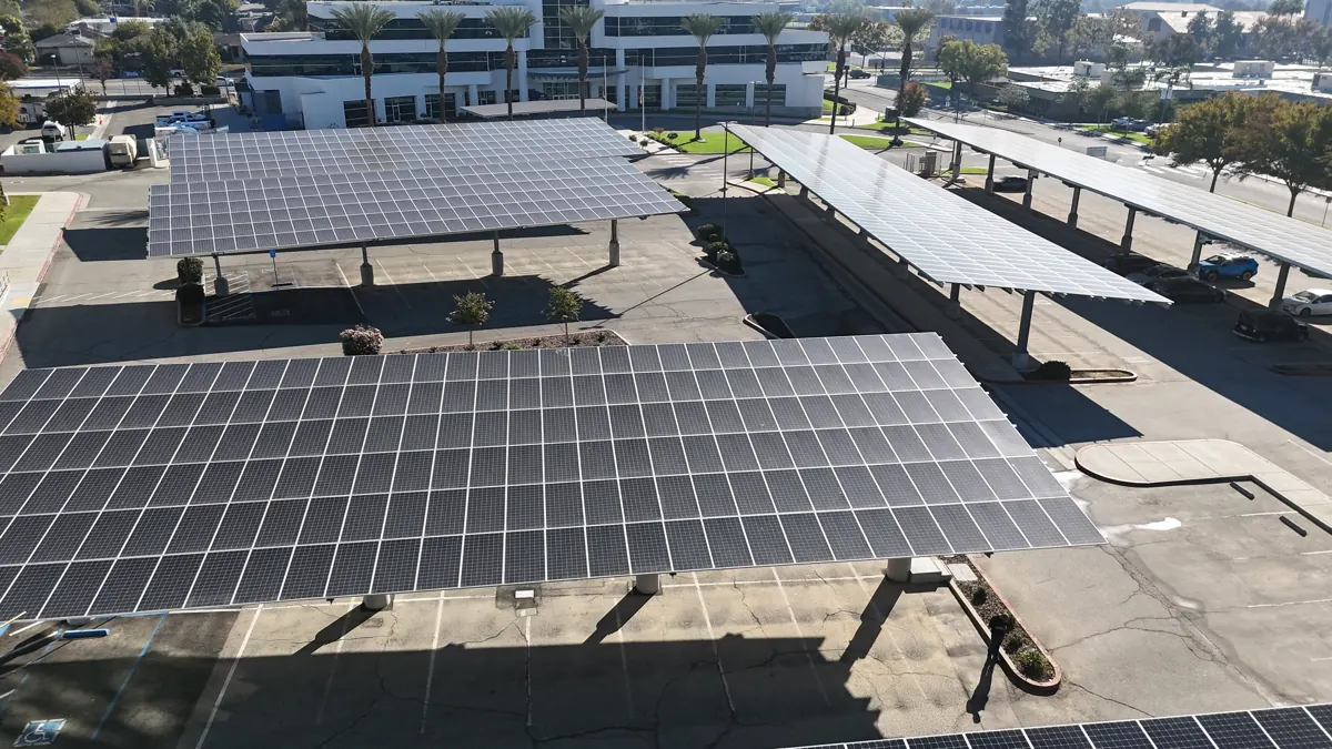 Drone view of solar carports over a parking lot at Sakata Seed in Bakersfield, CA