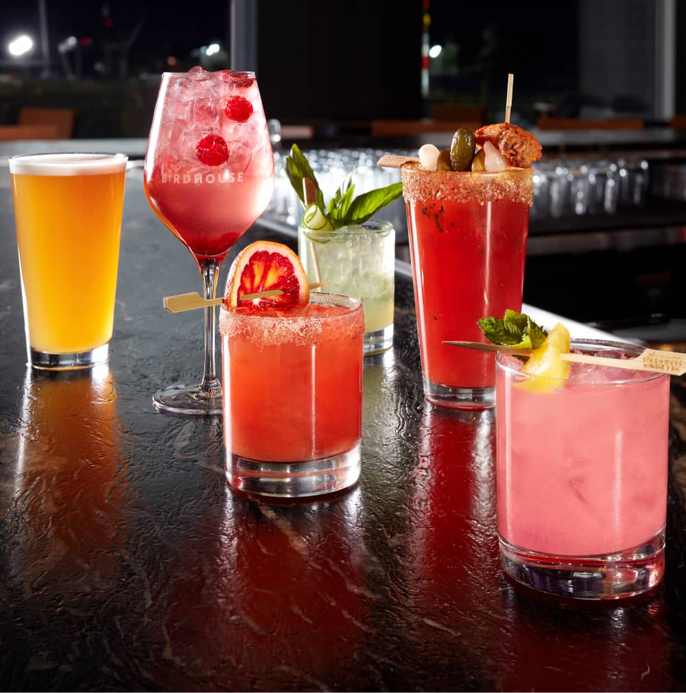 Many cocktails and beers on a bar counter