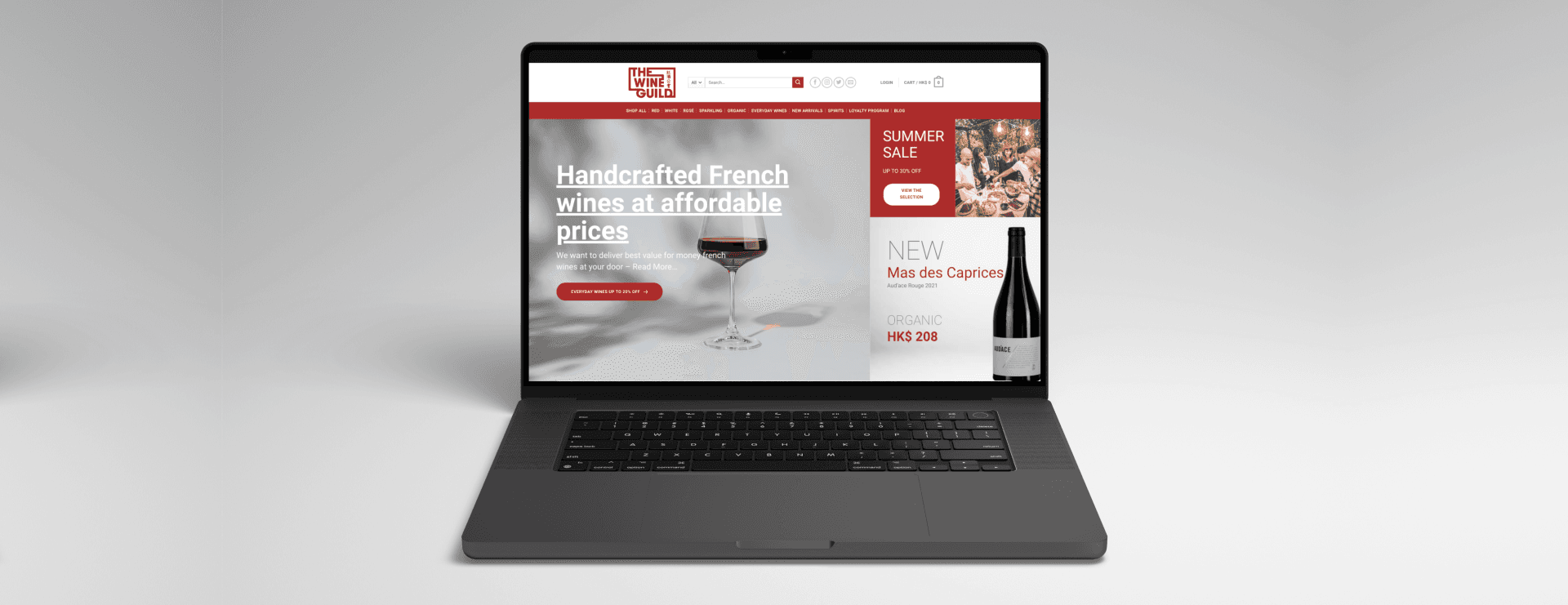 An open laptop displaying the Wine Guild website.