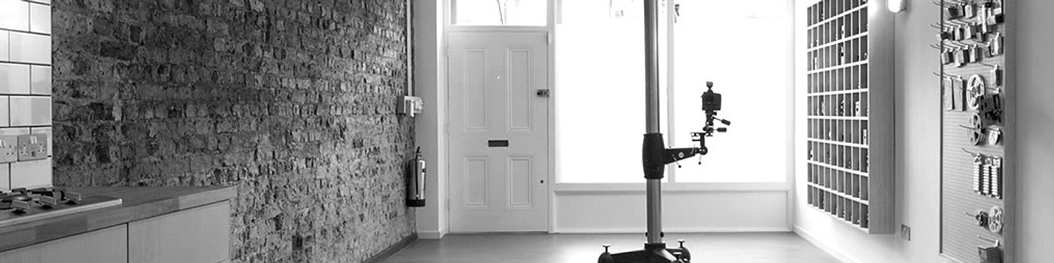 Modern industrial kitchen with exposed brick wall and pegboard tool organizer.