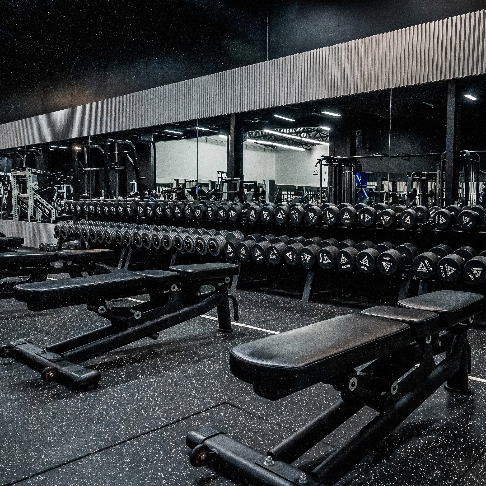Functional training gear at Legacy Muscle Universe Koh Samui, with kettlebells and battle ropes in a dynamic fitness environment.
