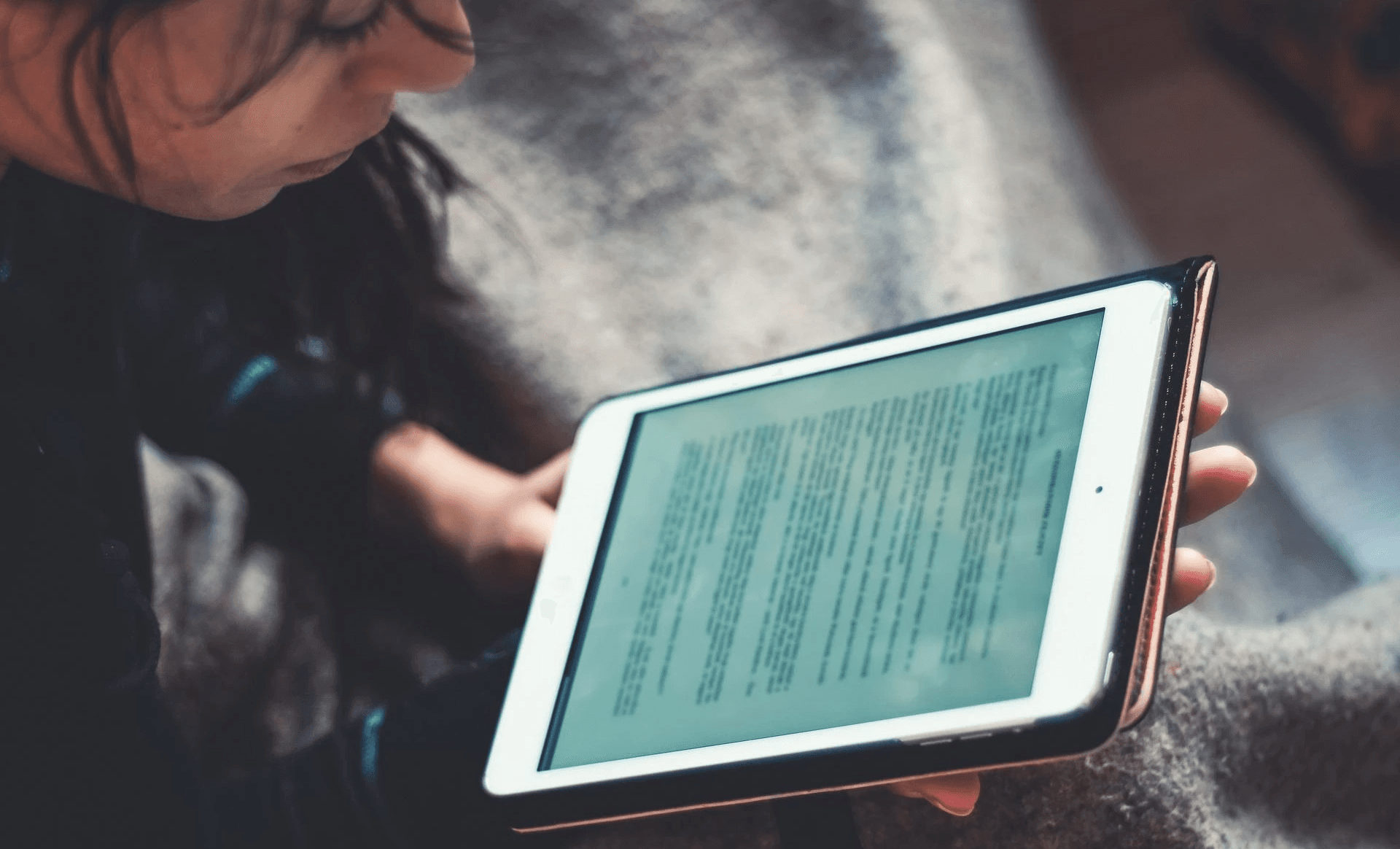 Woman reading from tablet - Best French Courses Online 