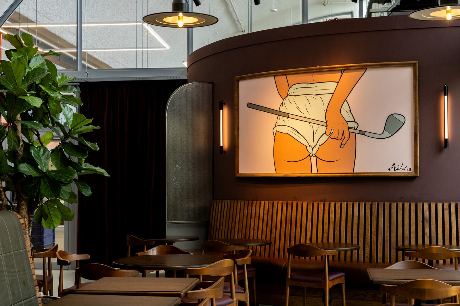 club-birdies-amsterdam-loungehoek-met-golfillustratie-en-zithoek-bij-indoor-golf