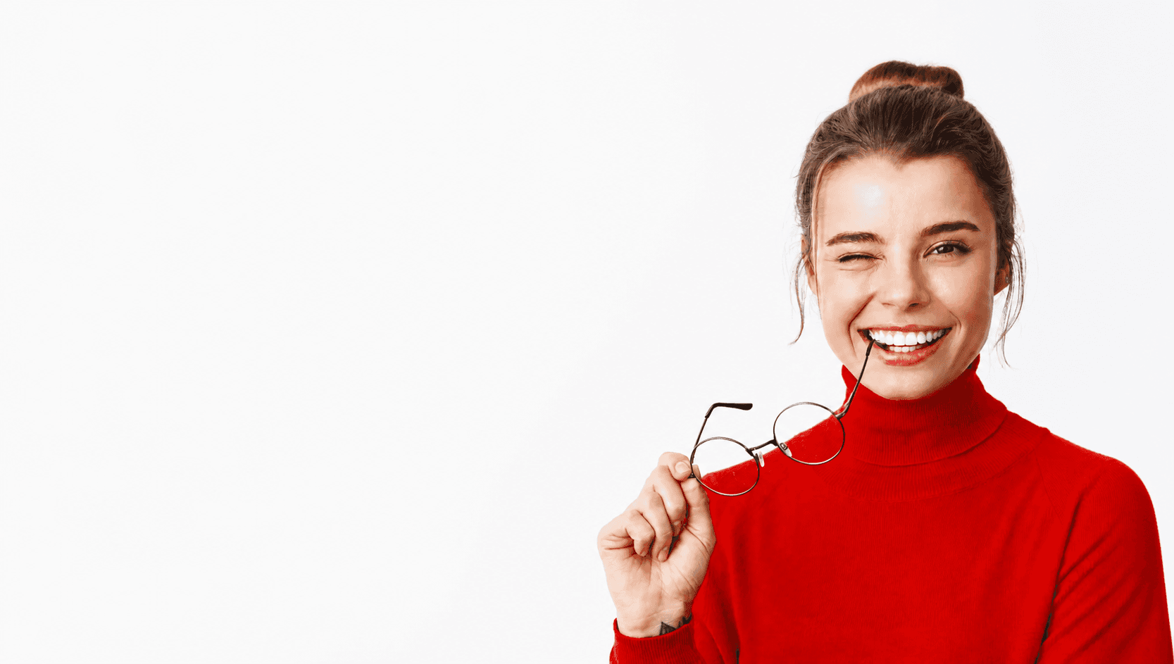 Smiling dental professional holding glasses with full head visible