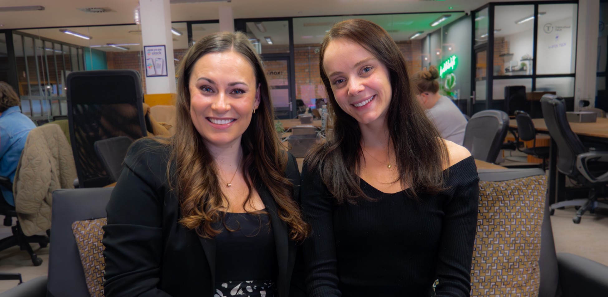 Three people smiling and posing in an office.