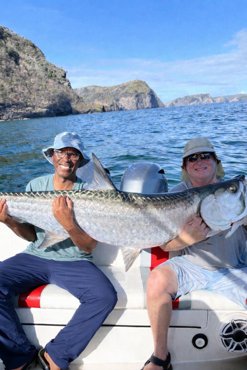 Two men holding a giant Tarpon