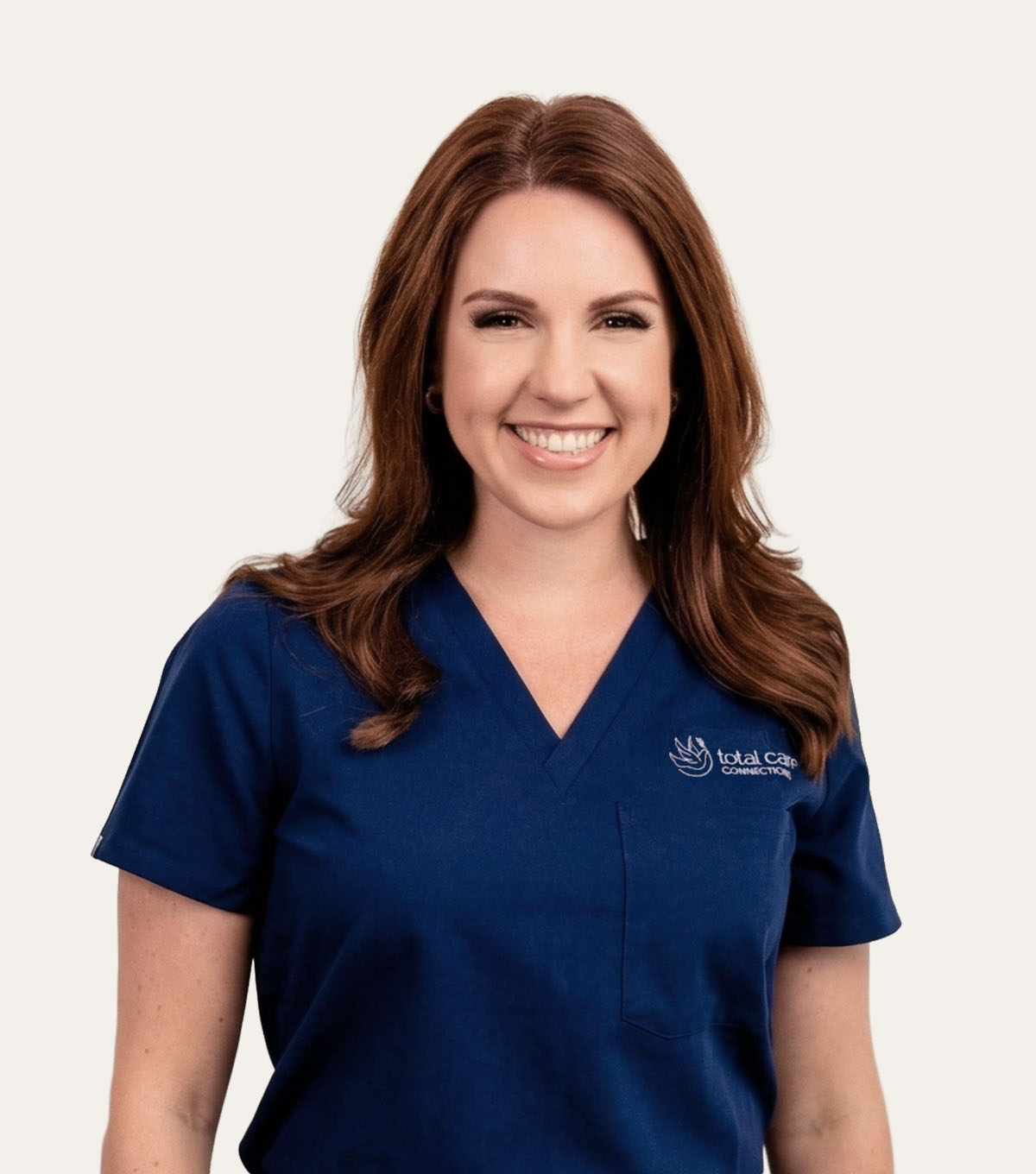 Woman in blue scrubs with Total Care Connection logo on the right side of her chest.