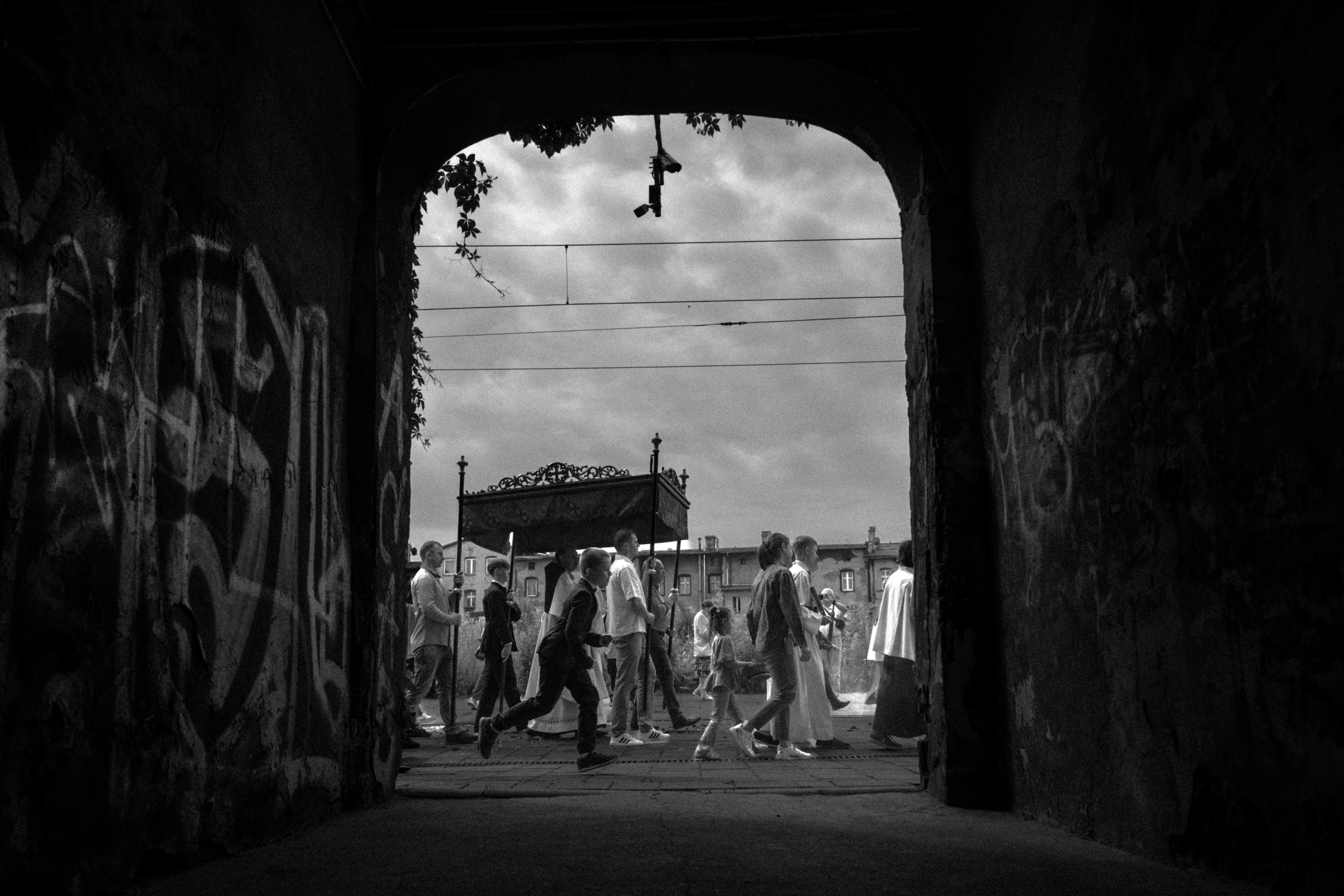 Catholic Corpus Christi procession walking through the streets of Lipiny, documentary photo.