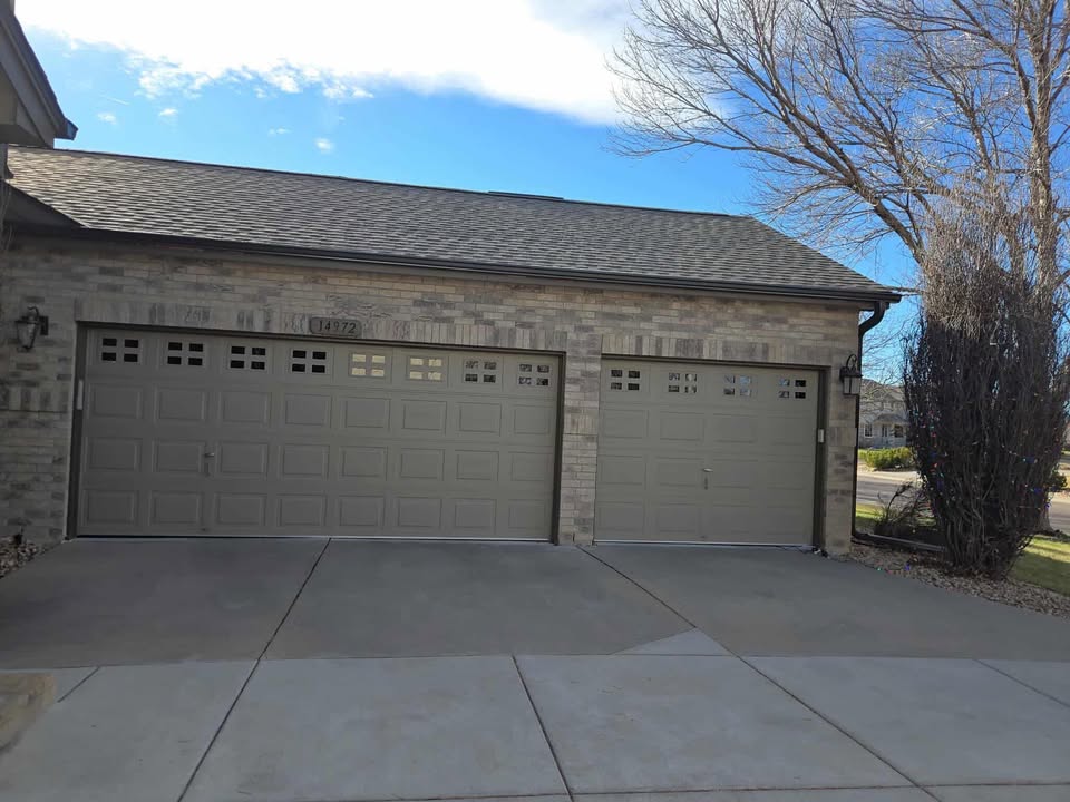 two men working on the roof of a house