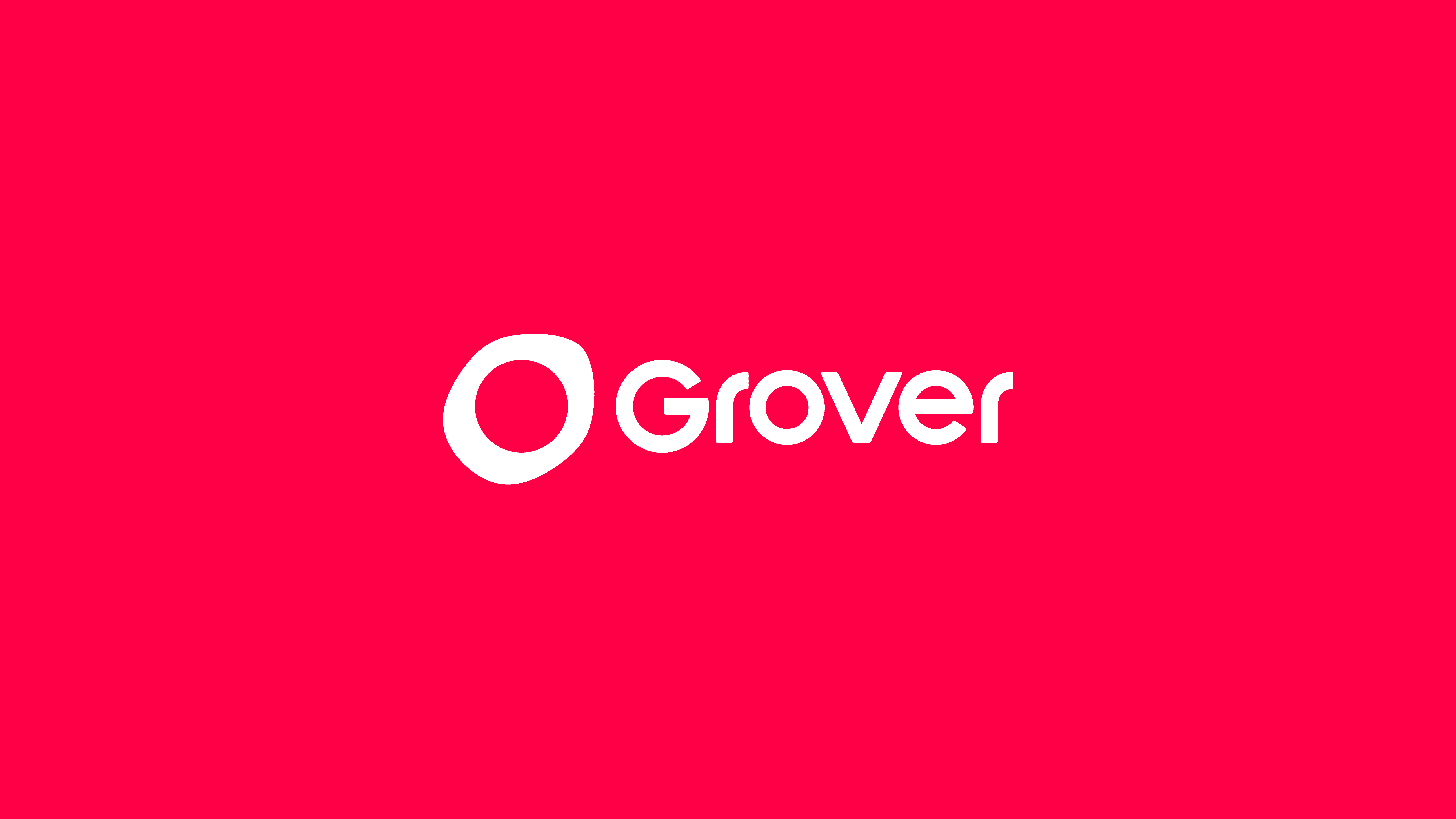 White Grover circle mark and wordmark centred on a flat crimson-pink field