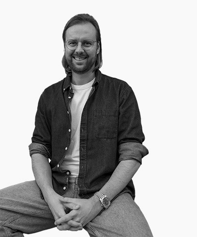 Stacked square glass jars filled with golden serum and bubbles, silver lids—luxury skincare packaging on a light background.
