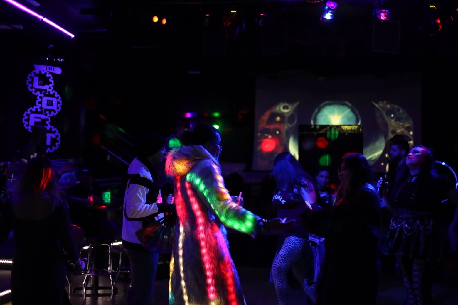 Colorful illuminated costume at a nightclub
