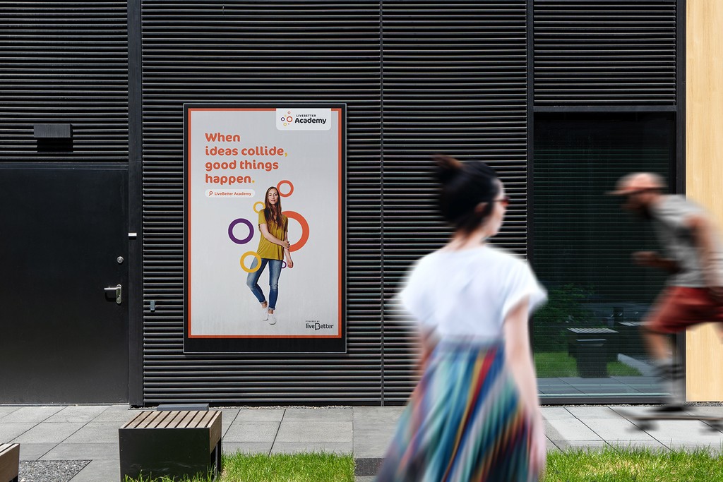 Woman looking at LiveBetter Academy Billboard