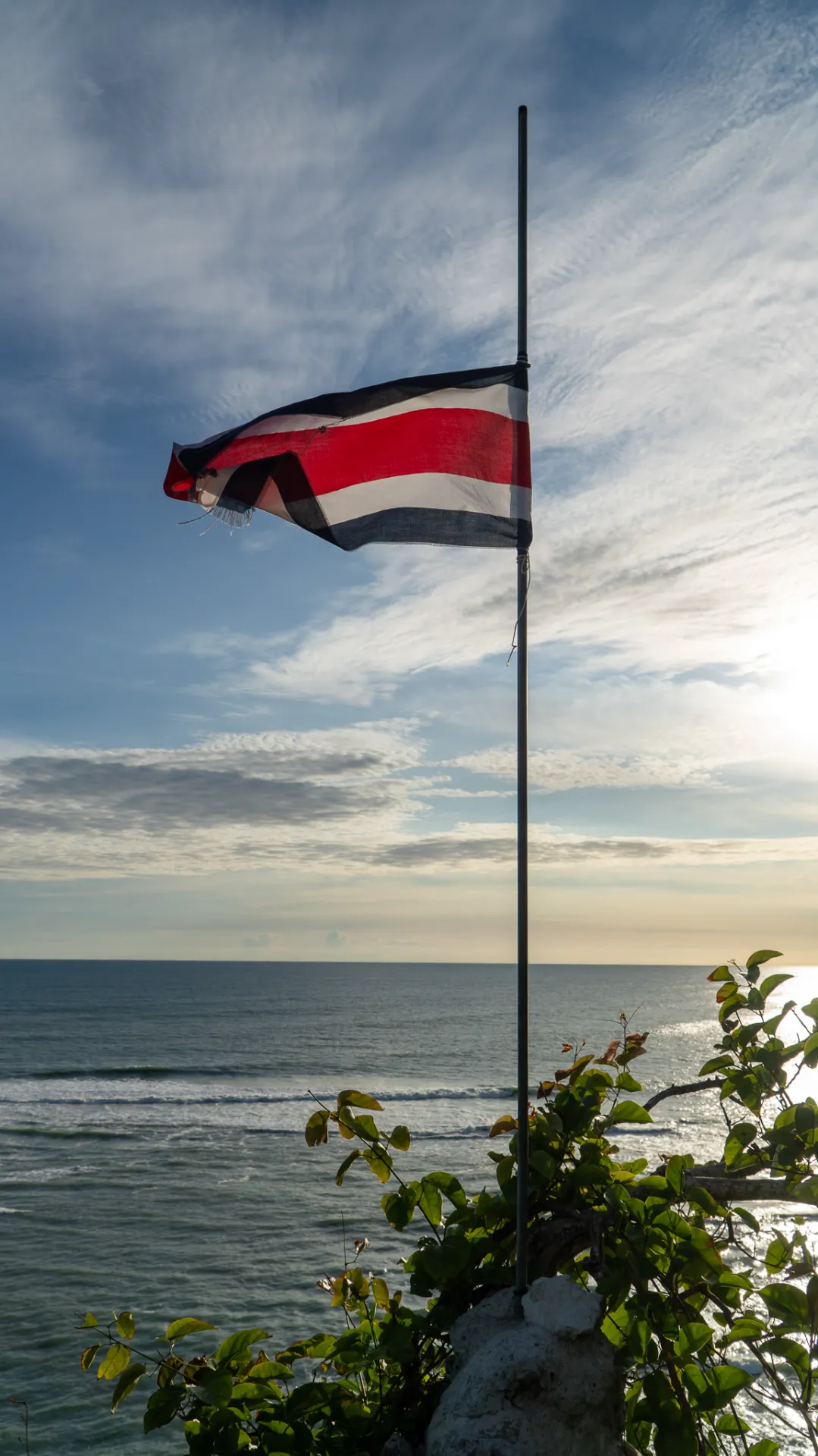 Costa Rican flag at the viewpoint over Playa Suecos in Malpaís, Costa Rica