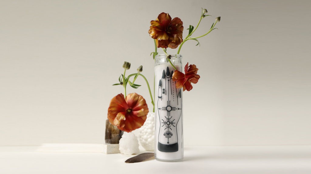 white candle with red and yellow flowers on white background
