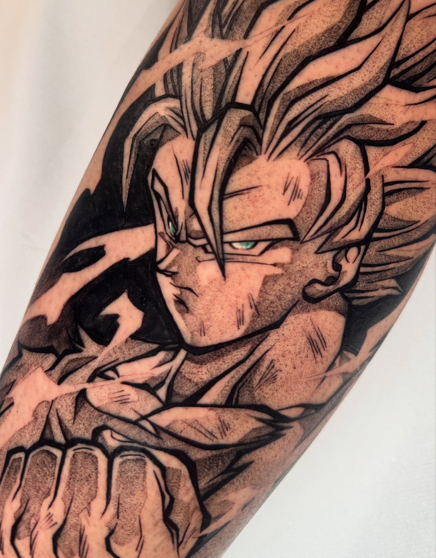 A forearm tattoo of Nezuko Kamado from Demon Slayer, depicted in a stylized anime art style. She is holding a sword.