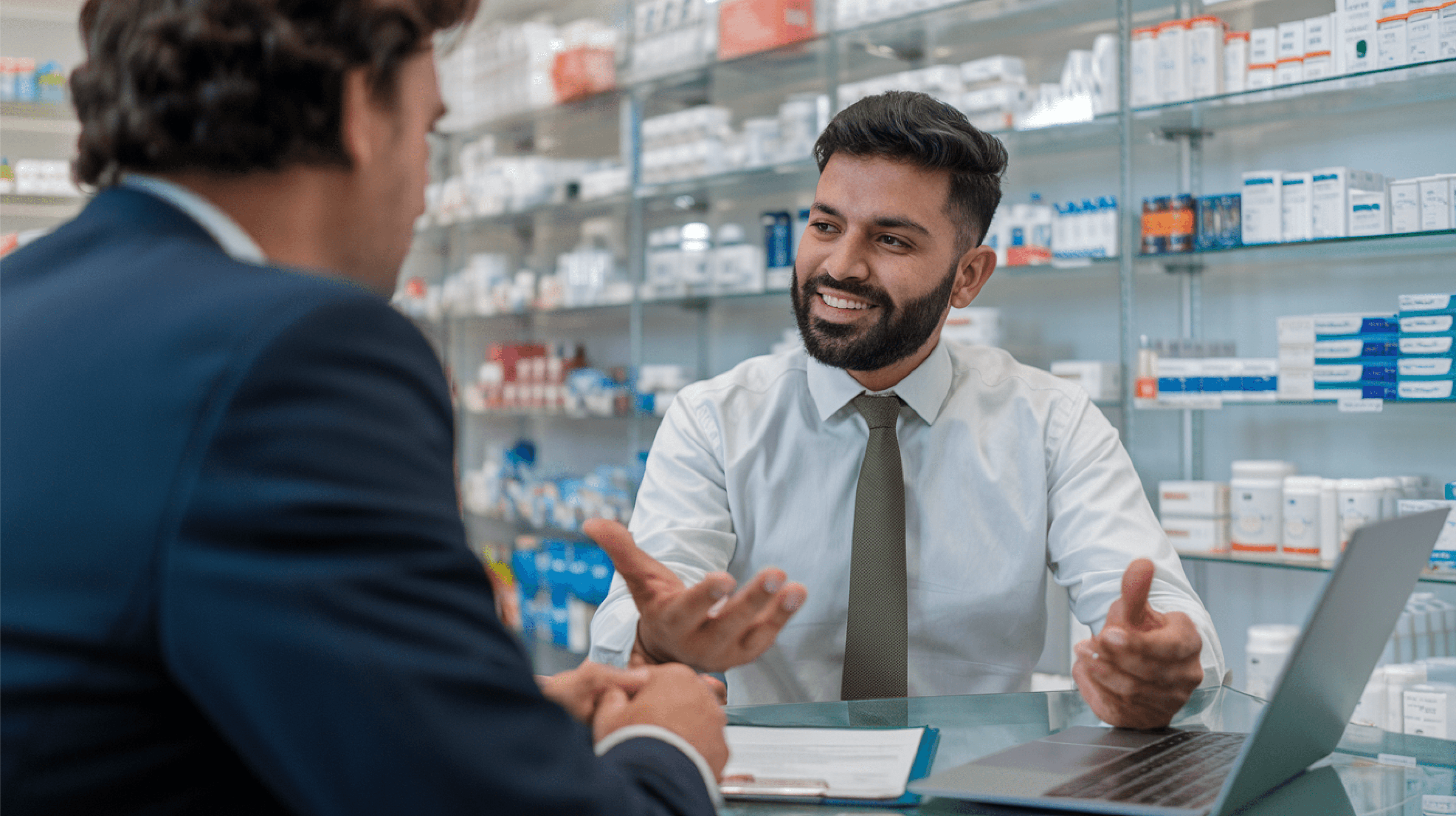 Pharmacist using digital purchase order system on touch screen monitor in pharmacy