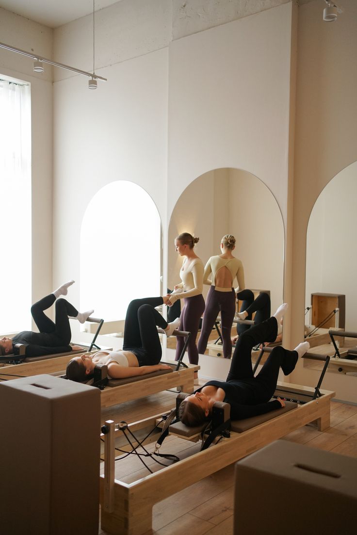 A luxurious indoor pool area with a panoramic view of a city at sunset. Comfortable lounge beds with soft fabrics surround the pool, while warm ambient lighting enhances the sophisticated atmosphere. The space combines modern elegance with a tranquil vibe.