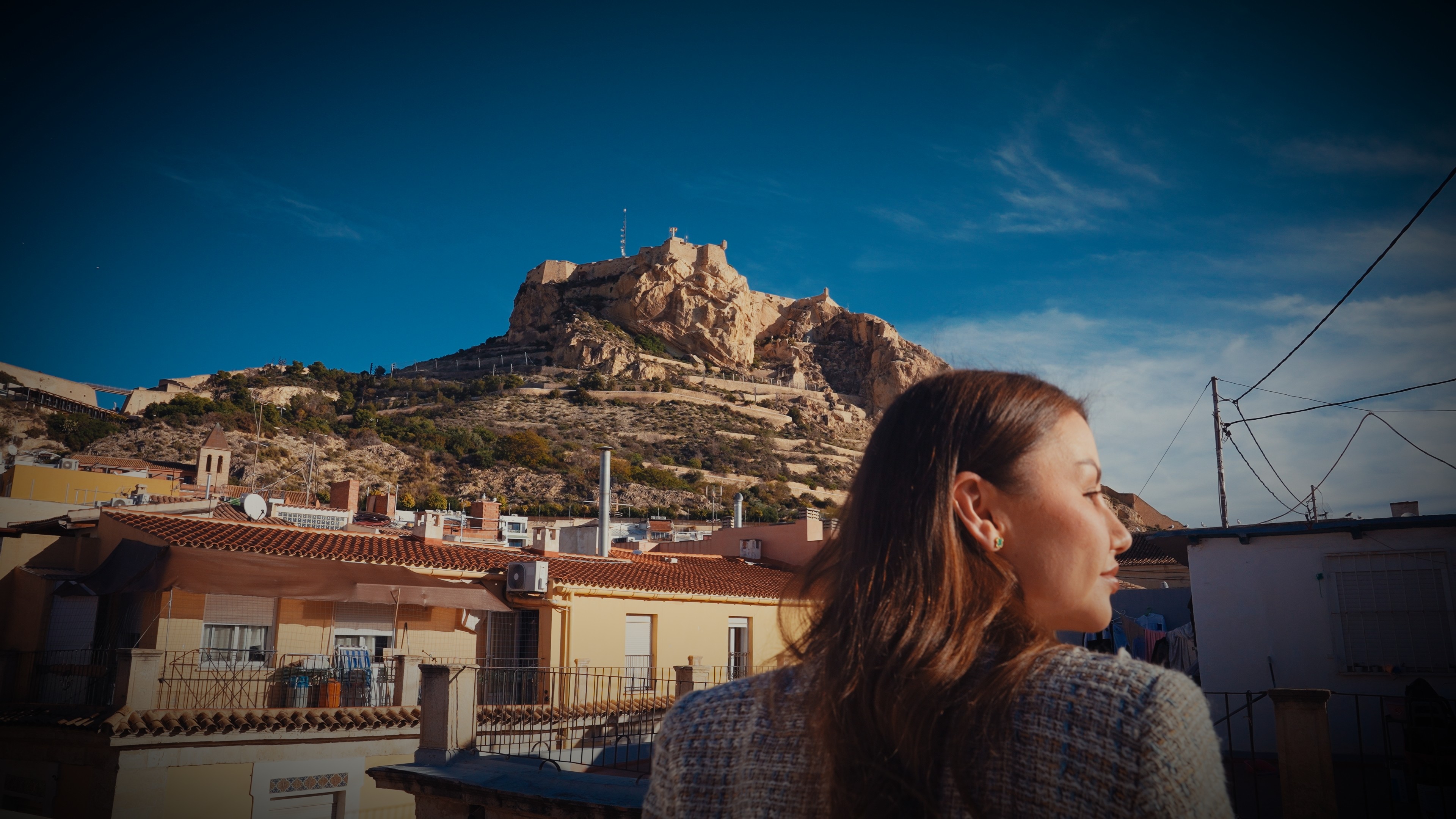 A man wearing a virtual reality headset, immersed in a digital experience, with a focused expression on her face.