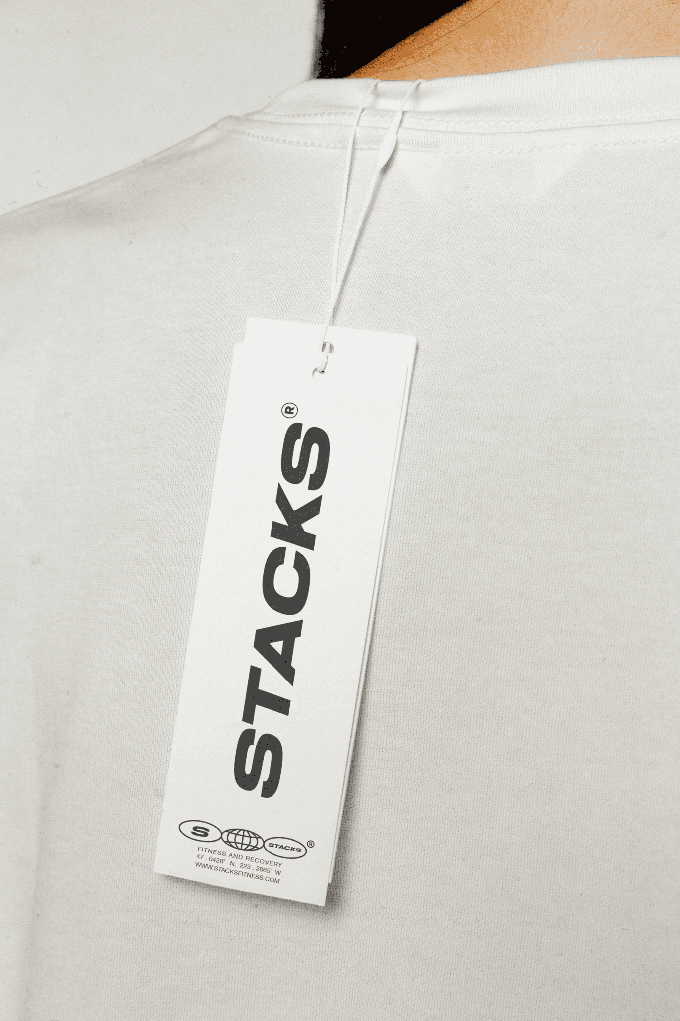 Clothing tag for Stacks activewear featuring logo and clean branding.