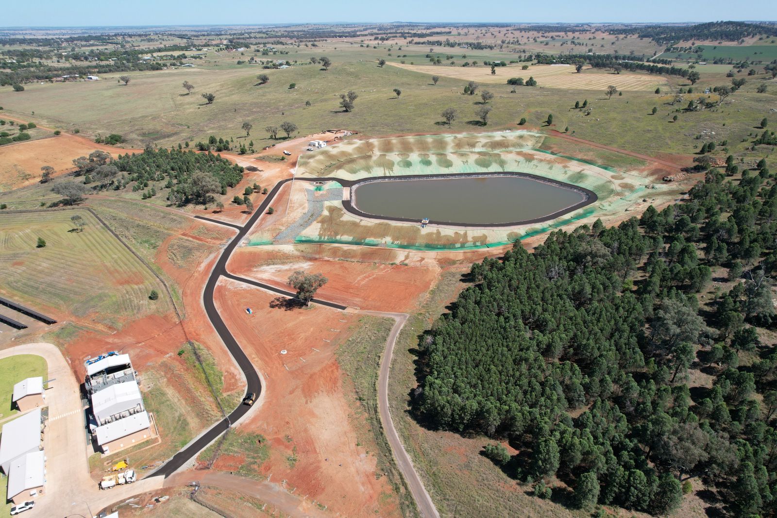 Aerial view of a newly constructed regional water storage basin managed by UMINEX, supporting long-term water security and infrastructure growth for Parkes Shire Council, NSW.