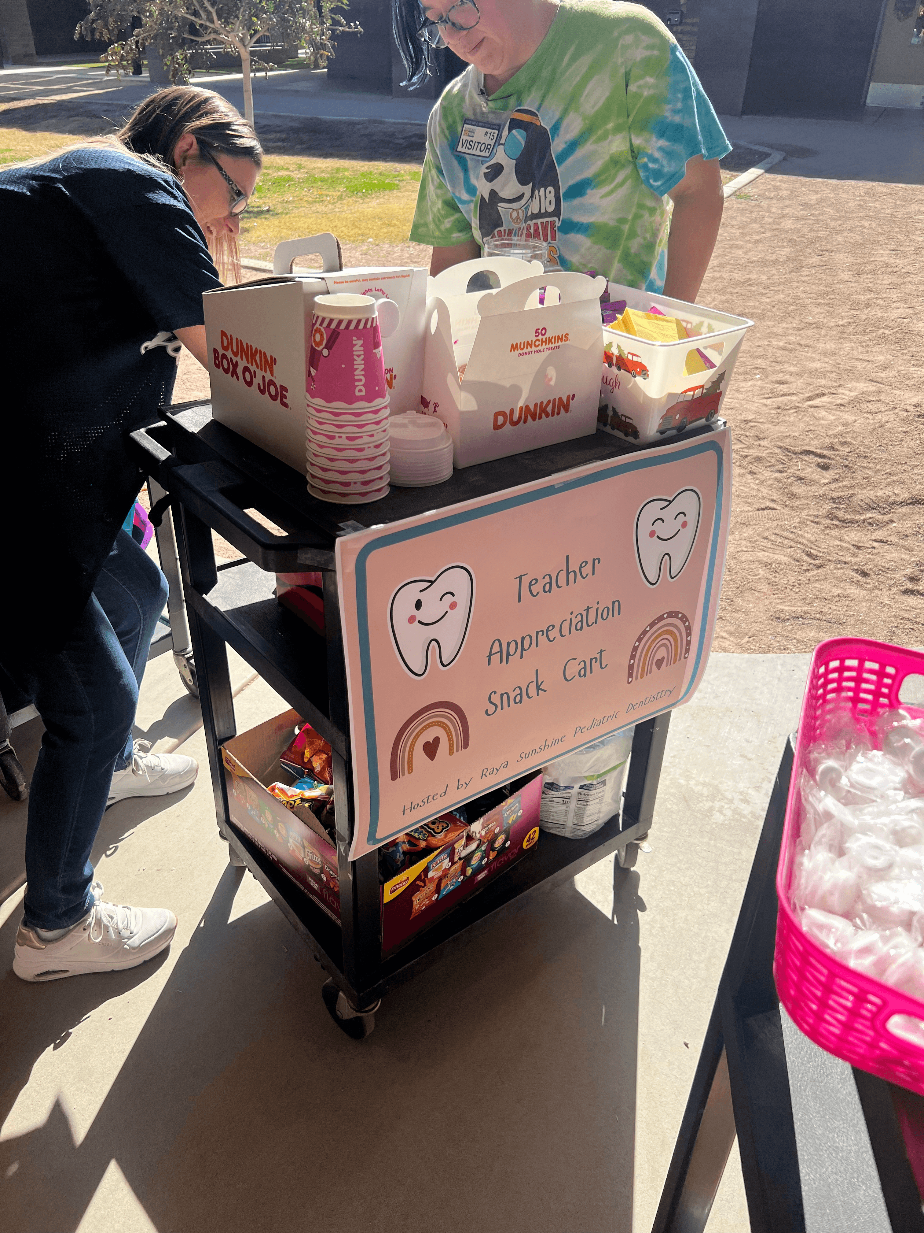 A decorated cart with dental-themed items set up for a community outreach event