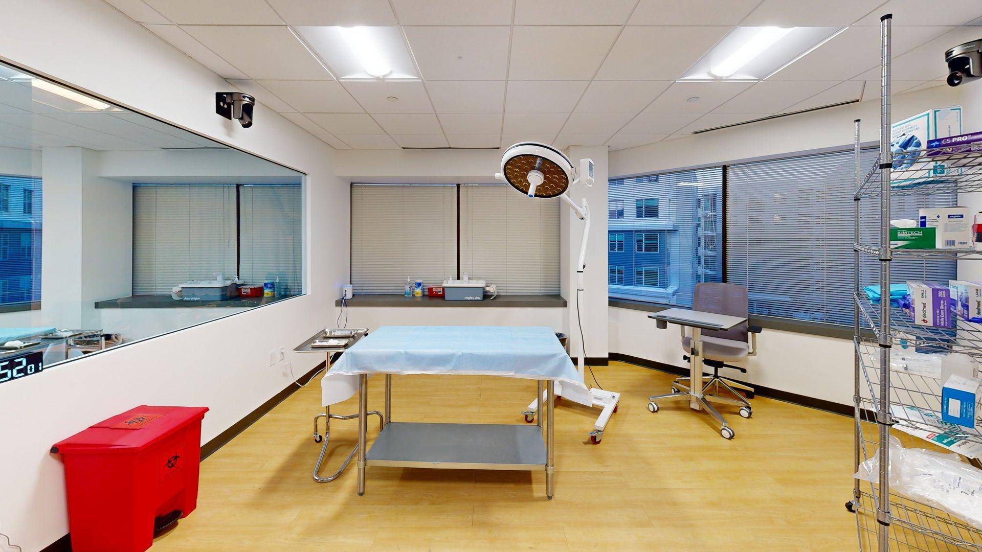 Operating room simulation suite in Cambridge, MA with surgical lighting, a procedure table, and integrated audiovisual recording