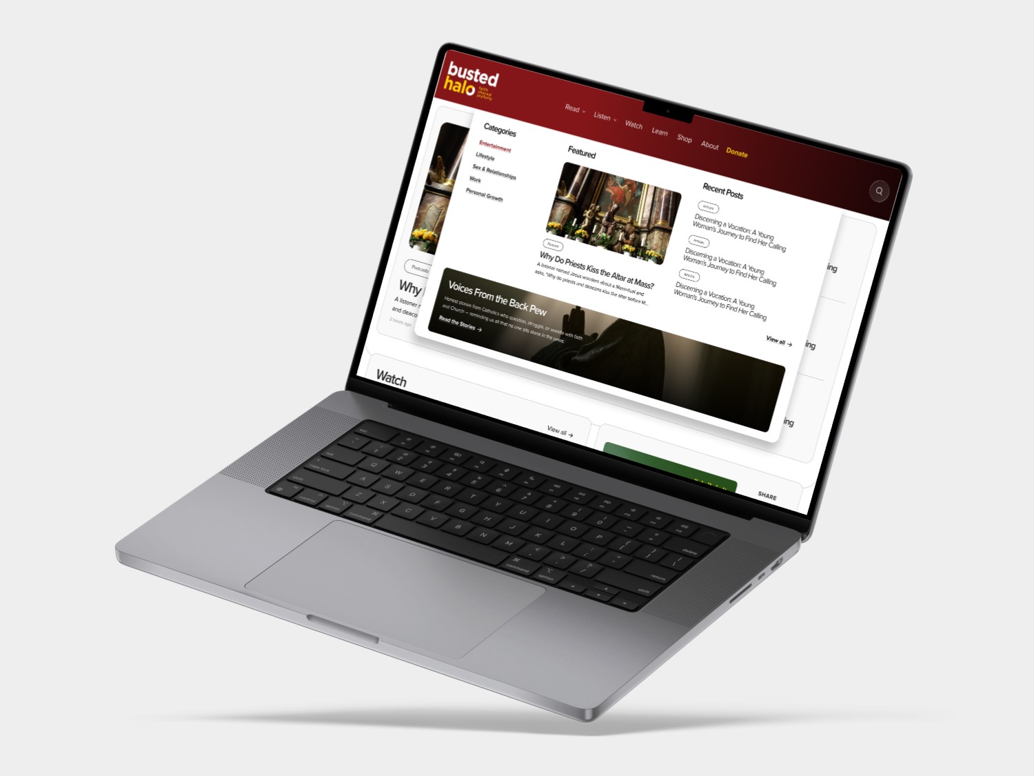 A lightweight laptop displaying a website with a red and black color scheme, slightly open on a white background.