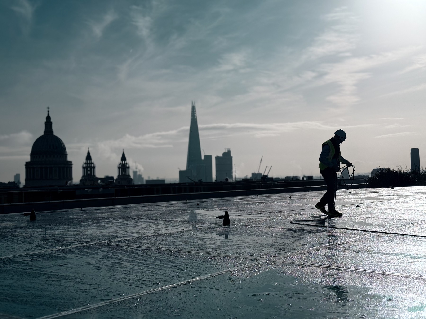 Rooftop access work above the London skyline