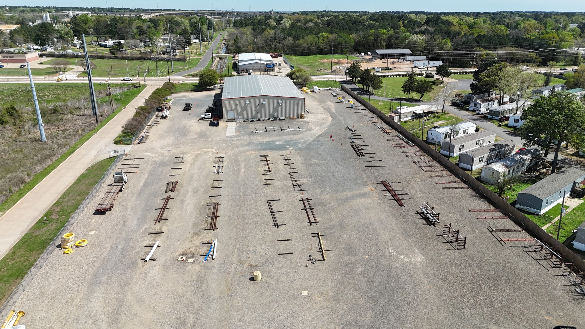 Reverse aerial view of the MRC Global Shreveport property showing the full yard and building footprint.
