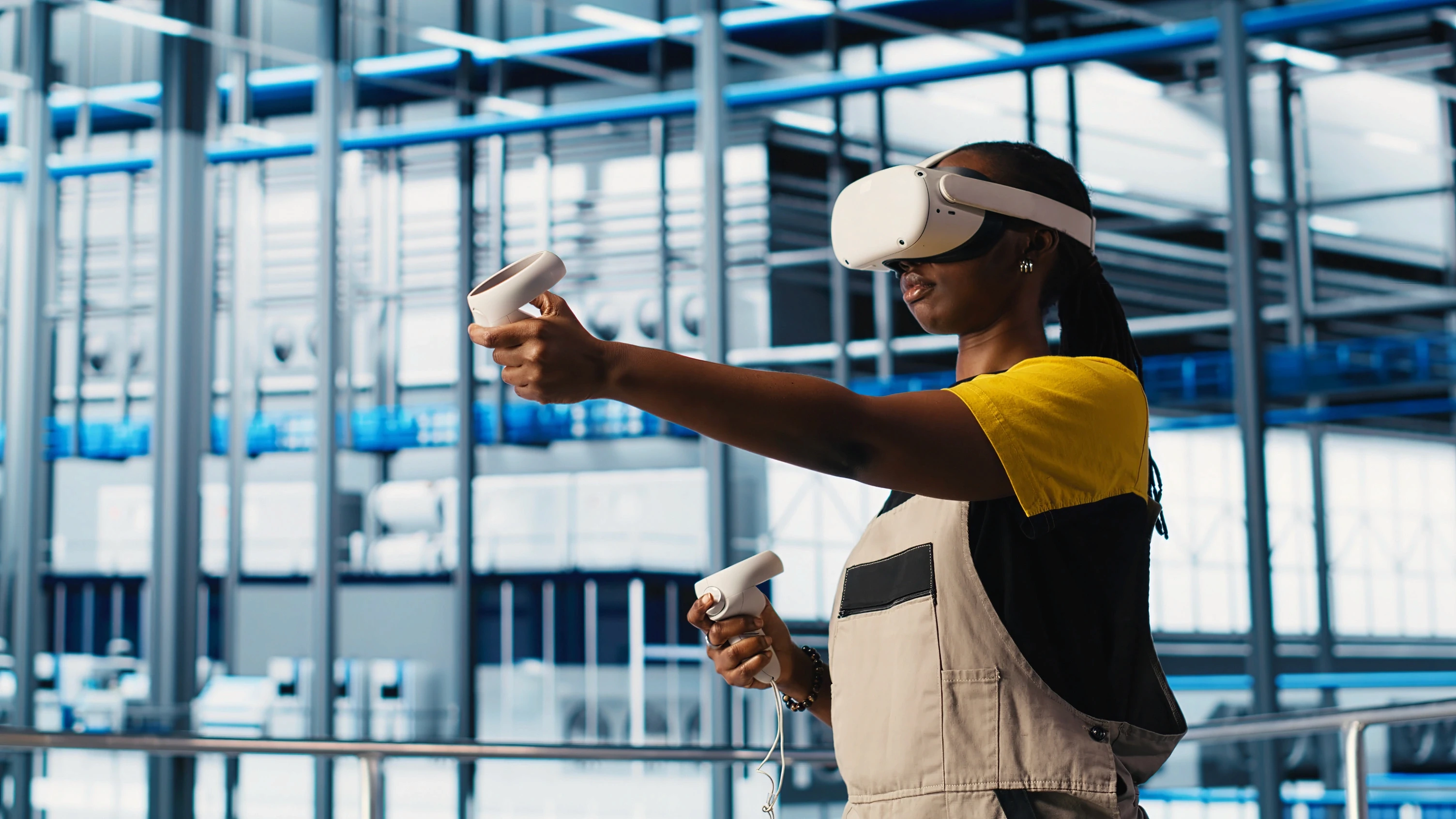 Warehouse worker wearing a VR headset and holding two controllers while completing an industrial training simulation