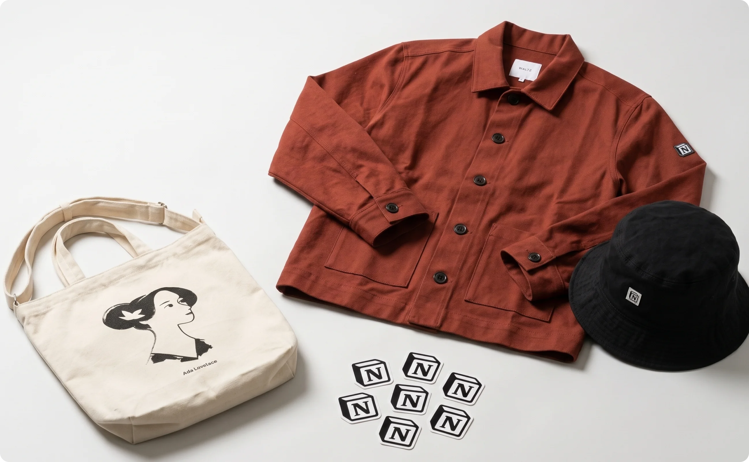 Different Notion swag items including a bucket hat, a tote bag, stickers, and a jacket.