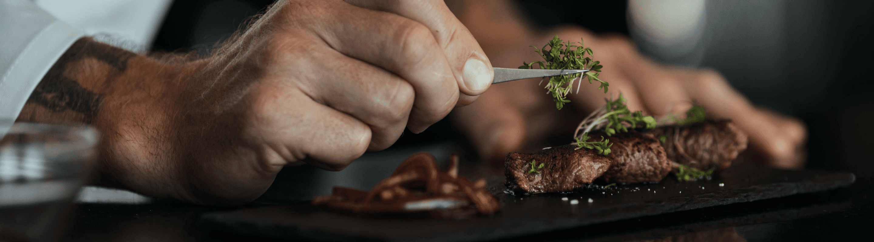 A chef carefully plating a dish