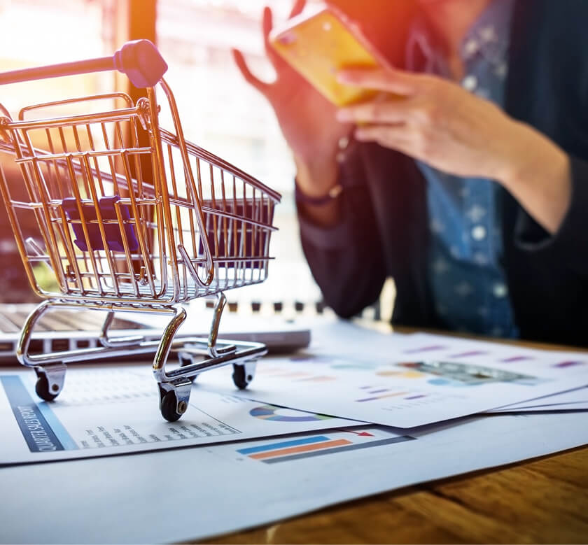 Shopping cart on a desk with digital devices