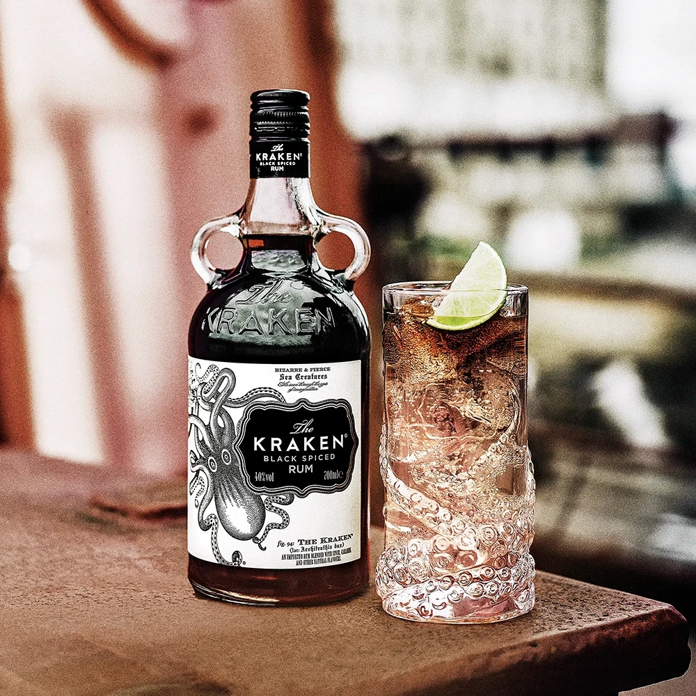 Kraken rum bottle with cocktail on a table in a bar