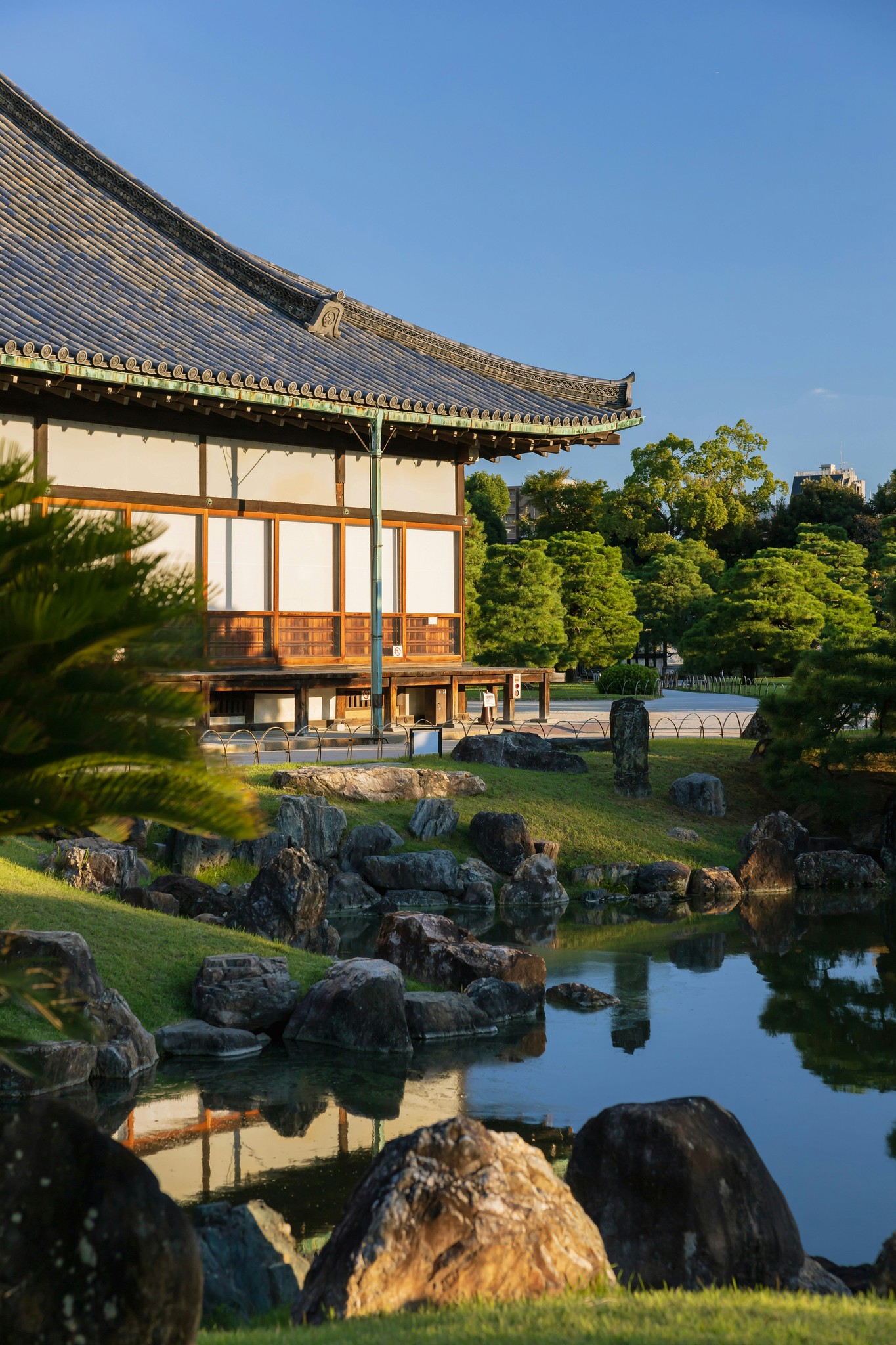 Japanese temple beside a serene pond.