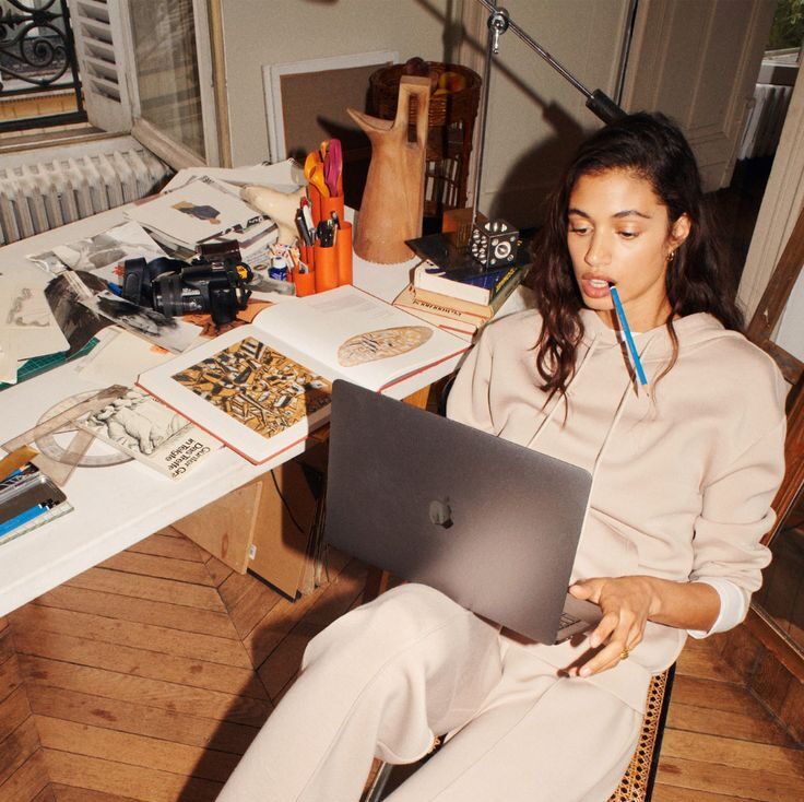 Person sitting in a modern office in front of a wall covered with notes and sketches.