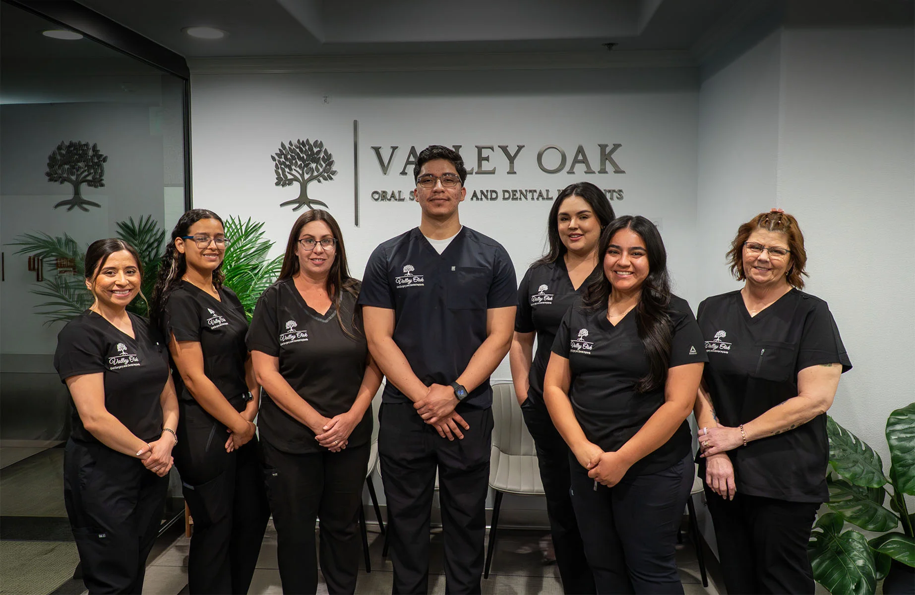 Team portrait of the Valley Oak Oral Surgery staff in Fresno, CA, featuring Dr. Justin Nassiri and his team in a modern and welcoming clinical environment.